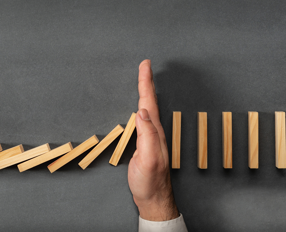 hand stopping dominoes