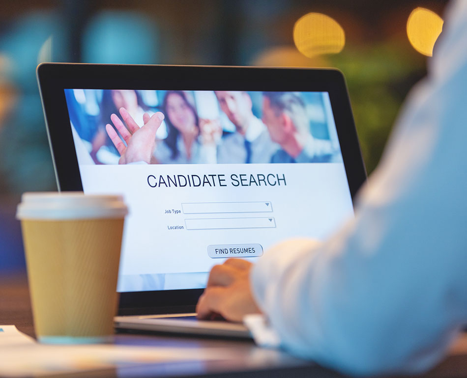 Businessman looking at recruitment website on a laptop computer.